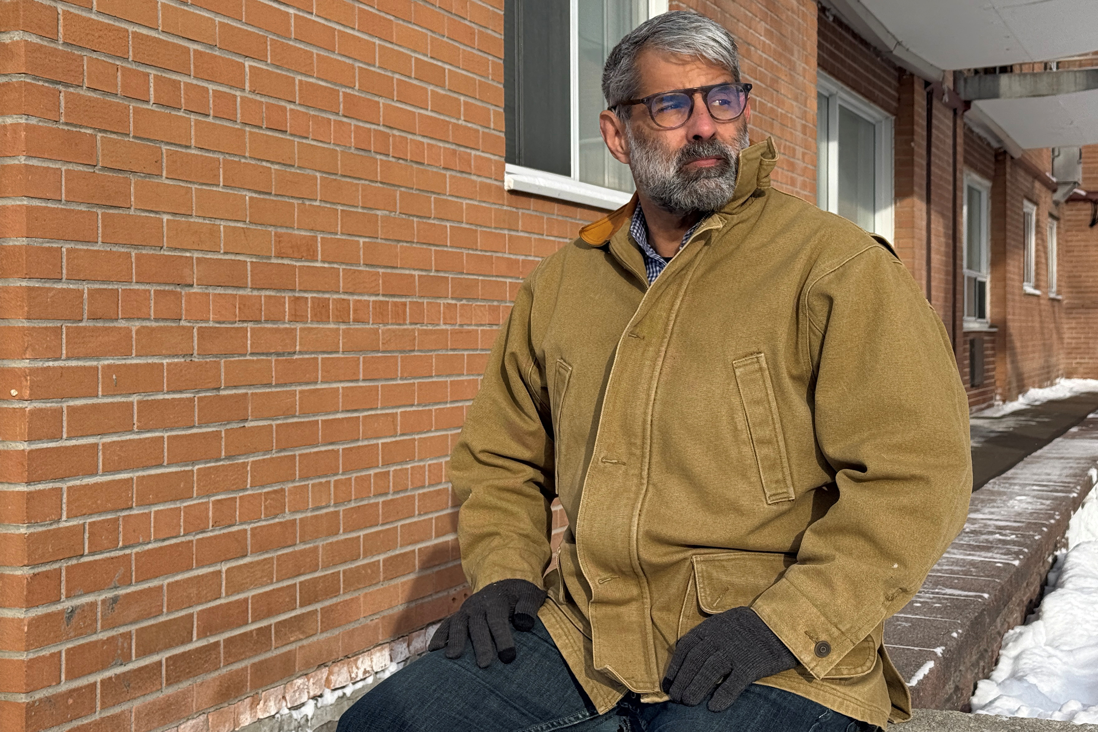 Venezuelan engineer Luis Cabana poses near his apartment in Ottawa