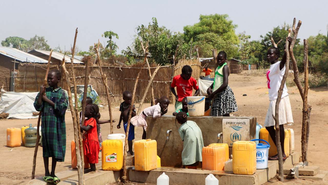 FILE PHOTO: Sudanese refugees collect water from a borehole at the Gorom Refugee camp