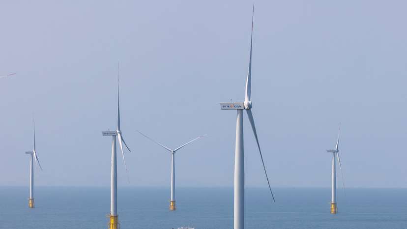 FILE PHOTO: A ship sails between wind turbines in the Taiwan strait off the coast of Pingtan Island