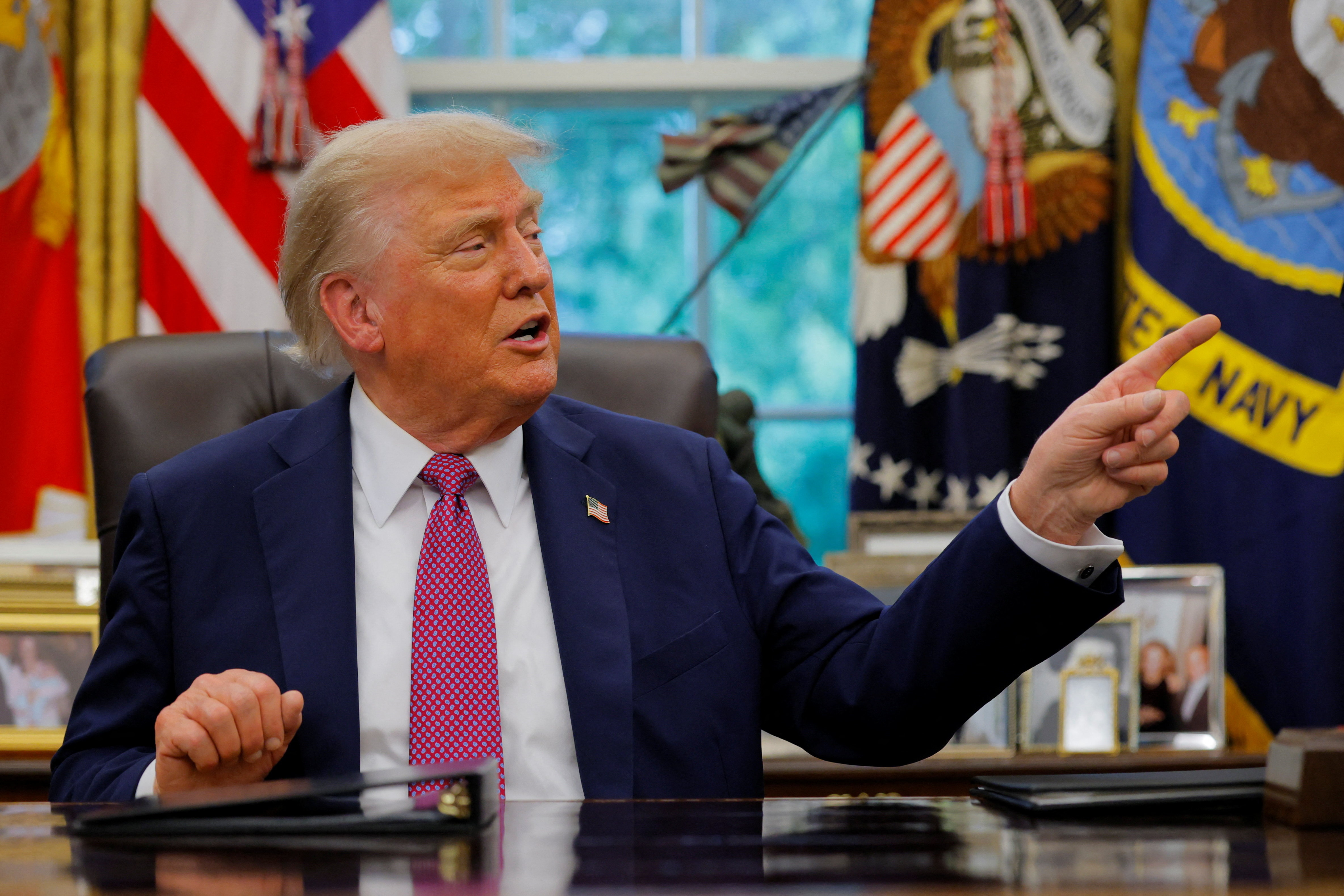 U.S. President Donald Trump signs an executive order at the White House in Washington, D.C.