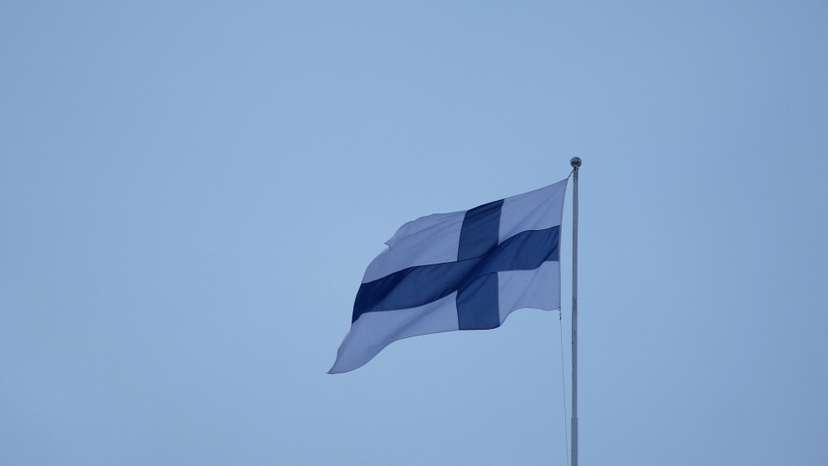 Finnish flag flies over the City Hall in Helsinki