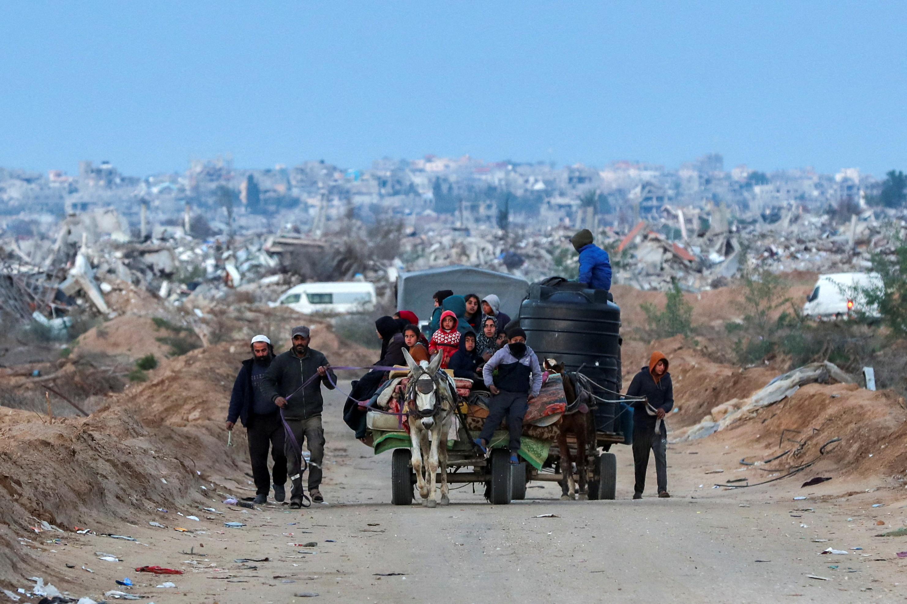Palestinians make their way after Israeli forces withdrew from the Netzarim Corridor, near Gaza City