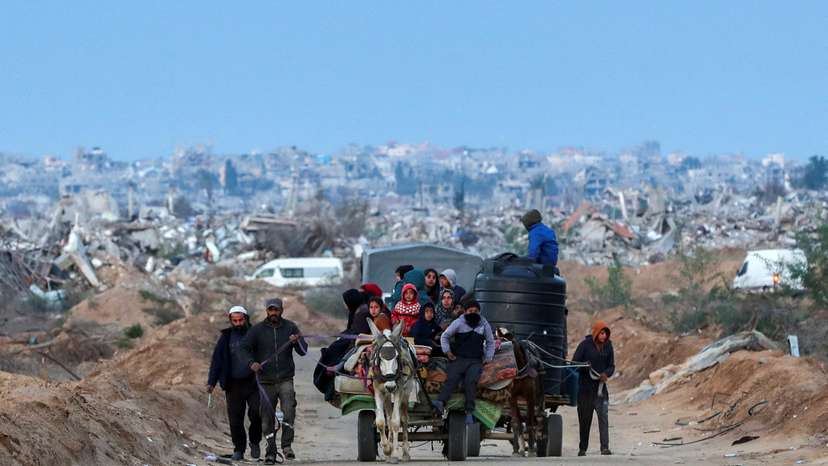 Palestinians make their way after Israeli forces withdrew from the Netzarim Corridor, near Gaza City