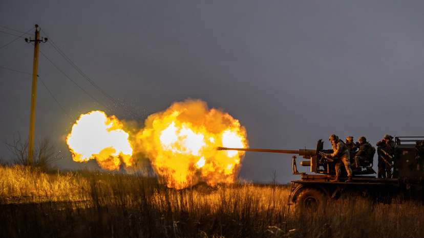 Ukrainian service members fire a S60 cannon towards Russian troops near the front-line town of Bakhmut