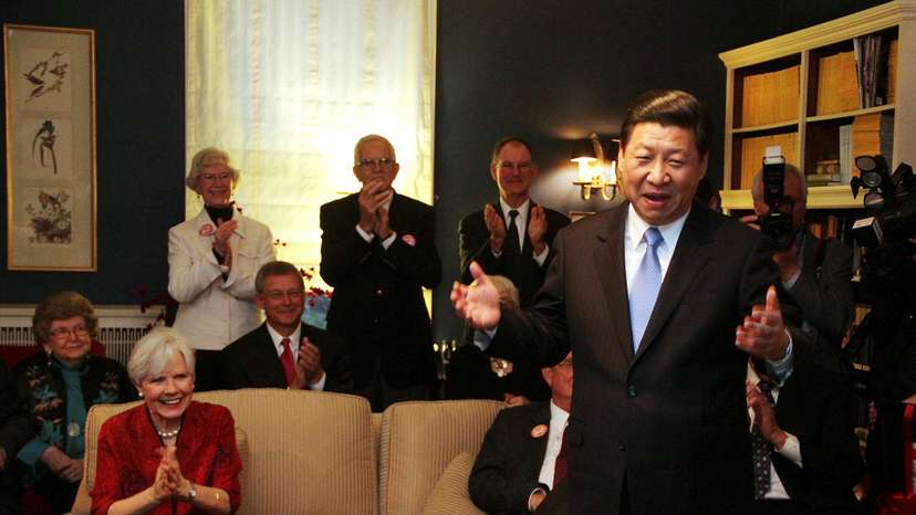 FILE PHOTO: China's Vice President Xi Jinping speaks at the home of Roger and Sarah Lande (2nd L) in Muscatine