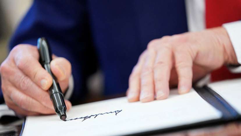 FILE PHOTO: U.S. President Donald Trump signs executive orders at the White House
