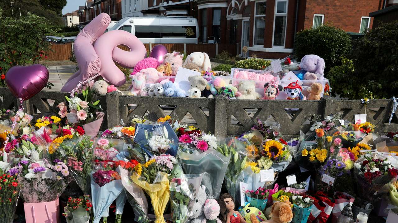 Floral tributes and soft toys are pictured near the scene where a teenage suspect was arrested after people were stabbed in Southport