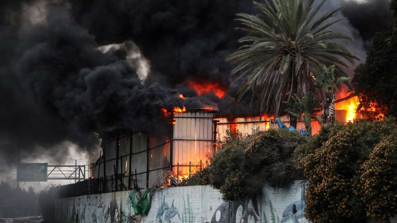 Fire ignited at the impact site following an Iranian missile strike, amid the U.S.-Israeli conflict with Iran, in central Israel