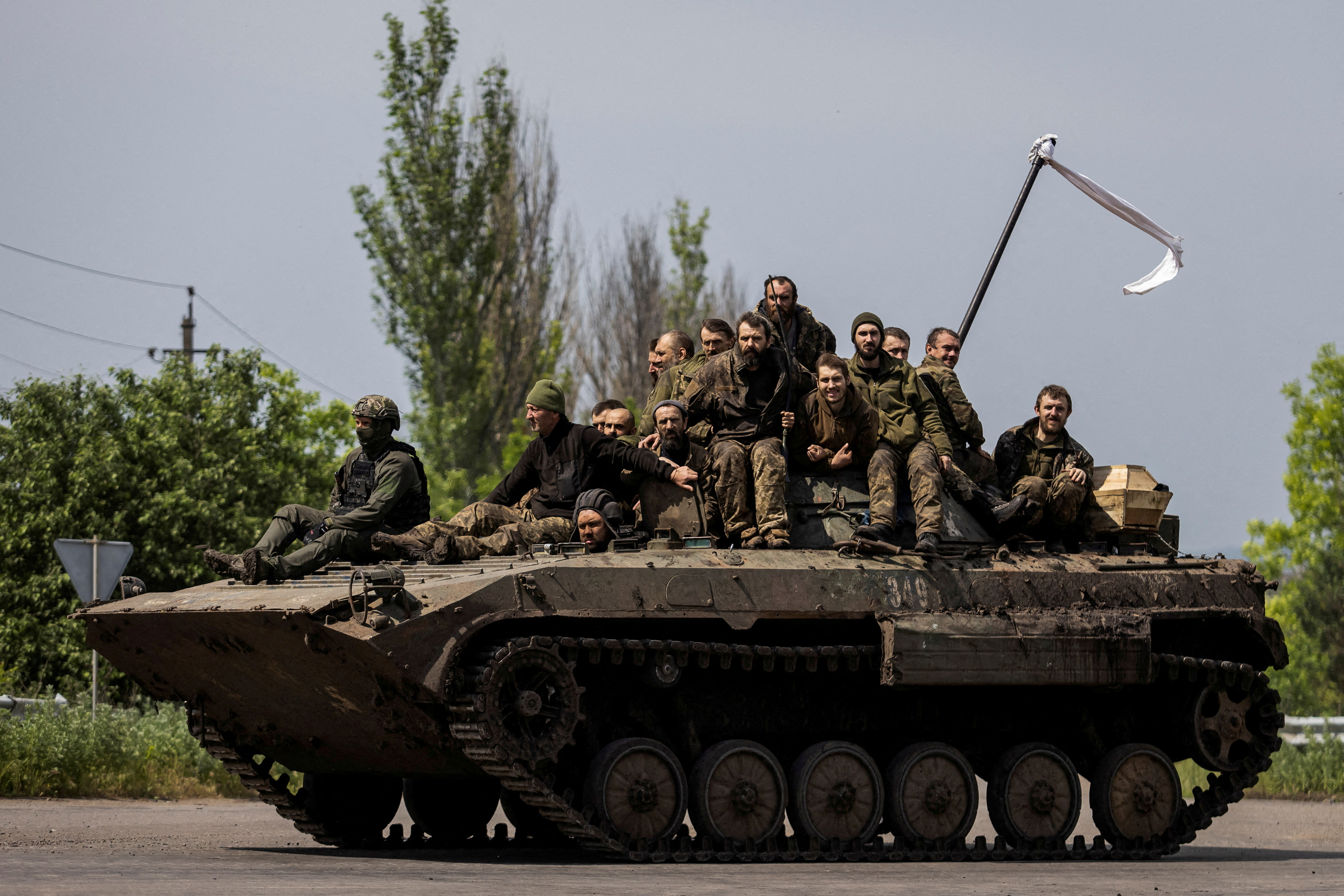 FILE PHOTO: Ukrainian prisoners of war (POWs) ride atop of an infantry fighting vehicle after a swap in Donetsk region