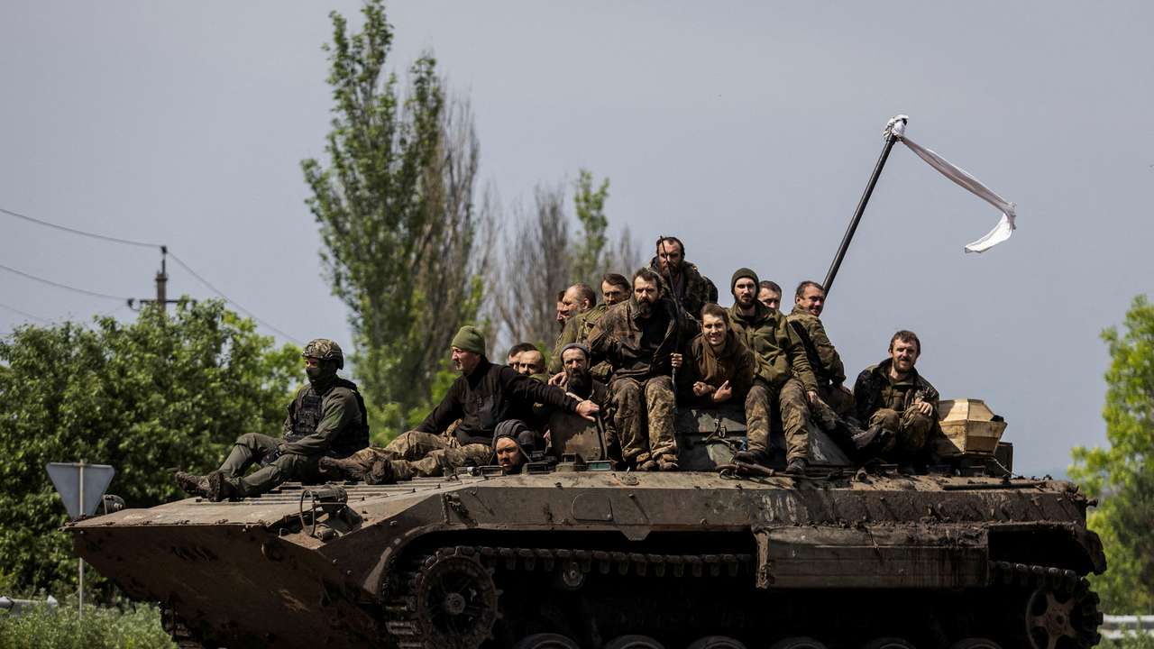 FILE PHOTO: Ukrainian prisoners of war (POWs) ride atop of an infantry fighting vehicle after a swap in Donetsk region