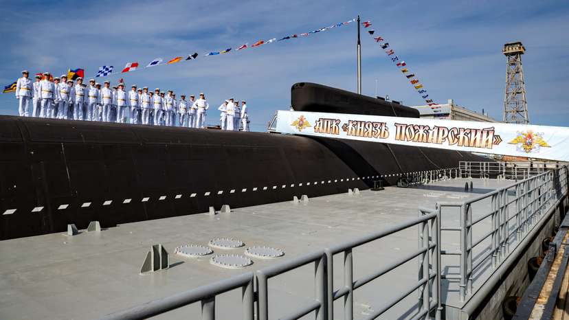 Crew members line up during a ceremony of raising a naval flag aboard the Knyaz Pozharsky nuclear-powered ballistic missile submarine in Severodvinsk