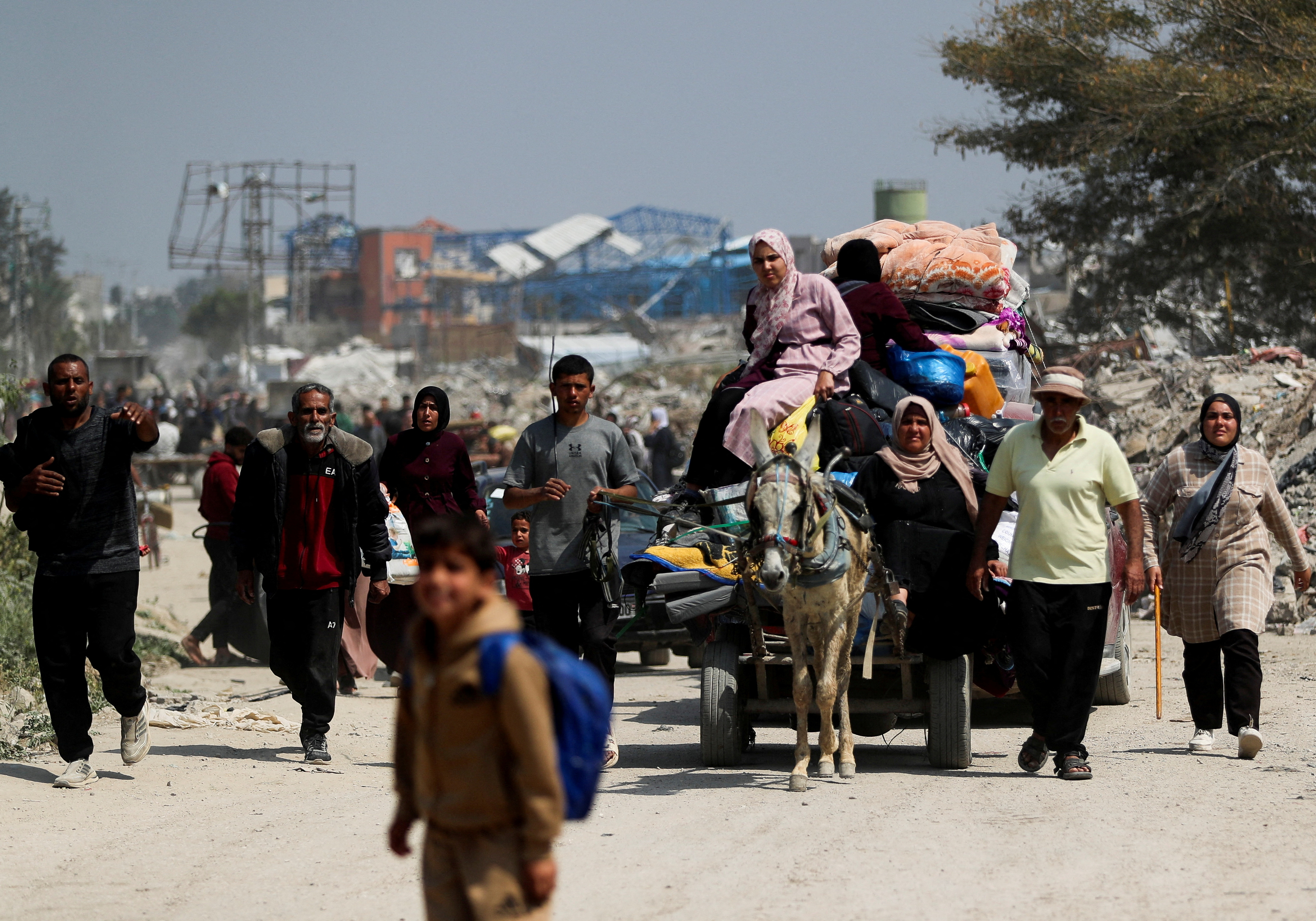 Palestinians make their way to flee their homes, in the northern Gaza Strip