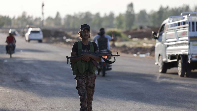 Syrian Bedouin fighters gather with weapons in Deraa