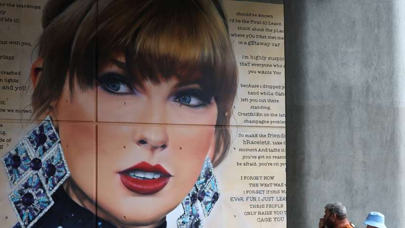 People view mural of Taylor Swift next to Wembley Stadium, as they attend Community Shield football match, at Wembley Stadium in London