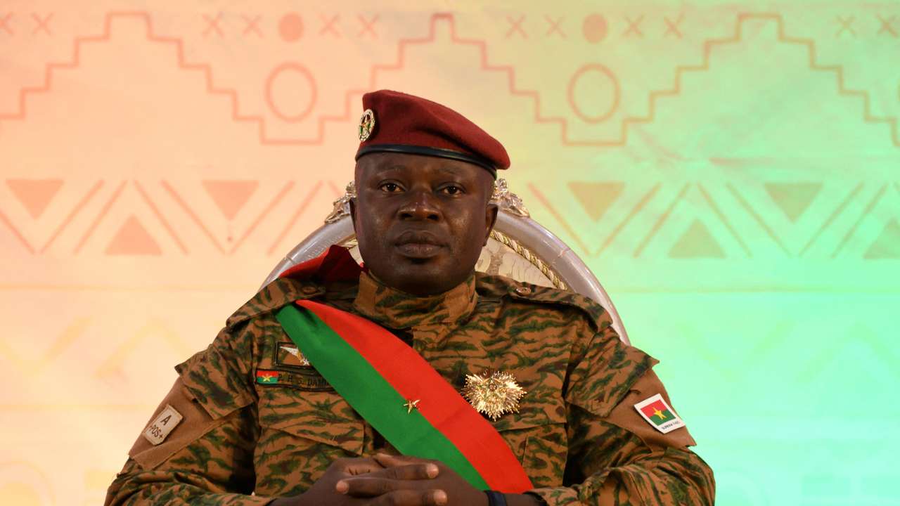 FILE PHOTO: Lieutenant Colonel Paul-Henri Damiba sits as he attends his swearing-in ceremony for a second time as president to lead a three-year transition after a national conference approved a transitional charter in Ouagadougou, Burkina Faso March 2, 2022. REUTERS/Anne Mimault/File Photo