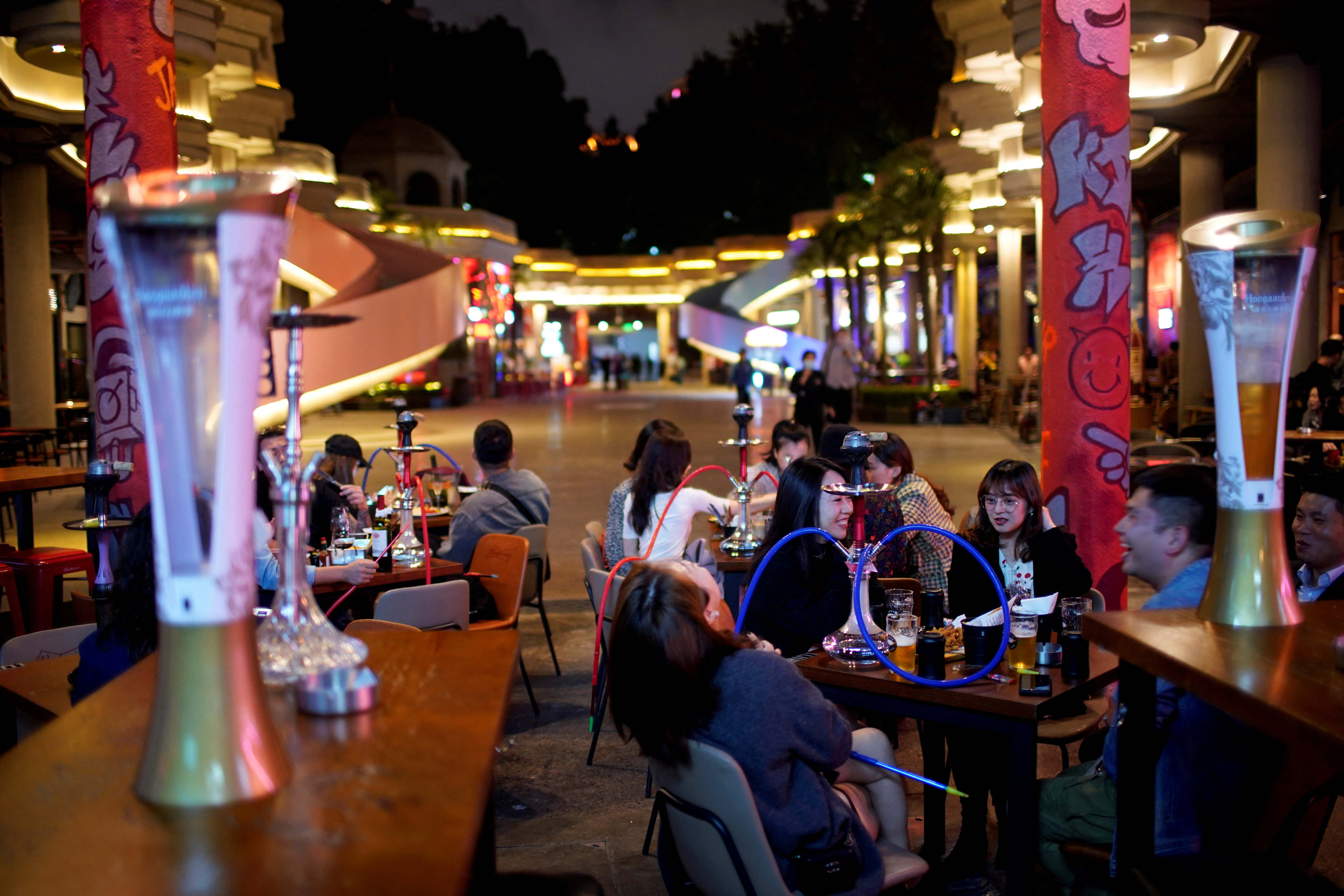 FILE PHOTO: People drink beer at a bar in Shanghai