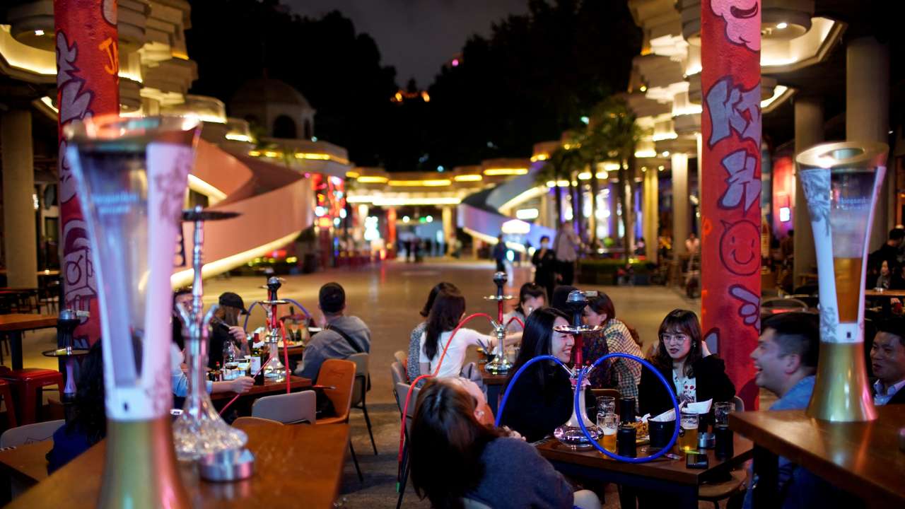 FILE PHOTO: People drink beer at a bar in Shanghai