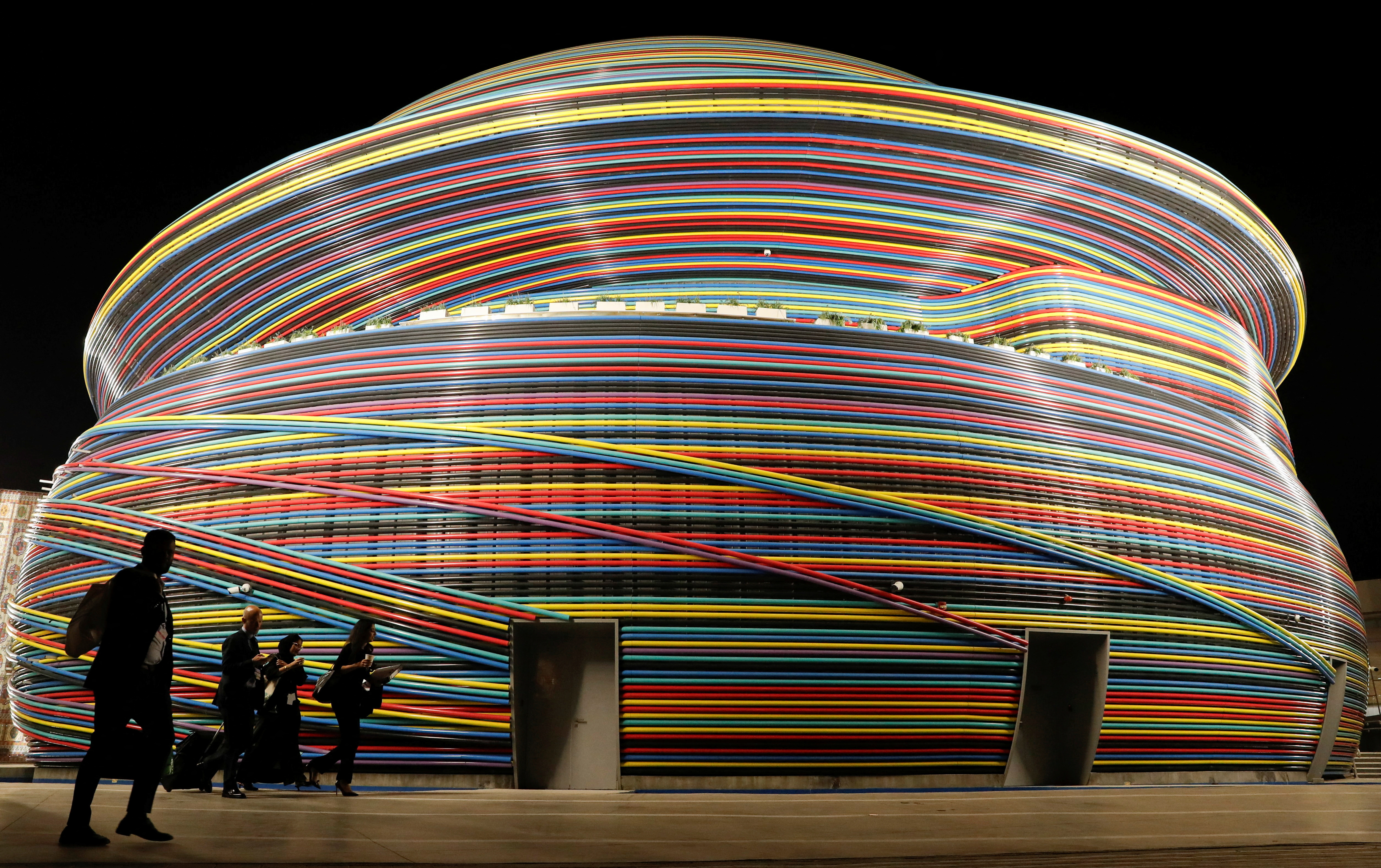 Delegates walk in front of the Russia Pavillion building at Dubai's Expo City during the United Nations Climate Change Conference (COP28) in Dubai