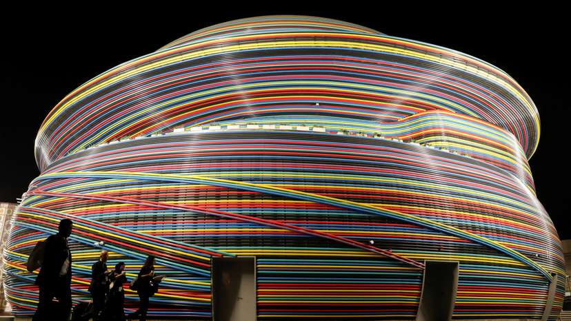 Delegates walk in front of the Russia Pavillion building at Dubai's Expo City during the United Nations Climate Change Conference (COP28) in Dubai
