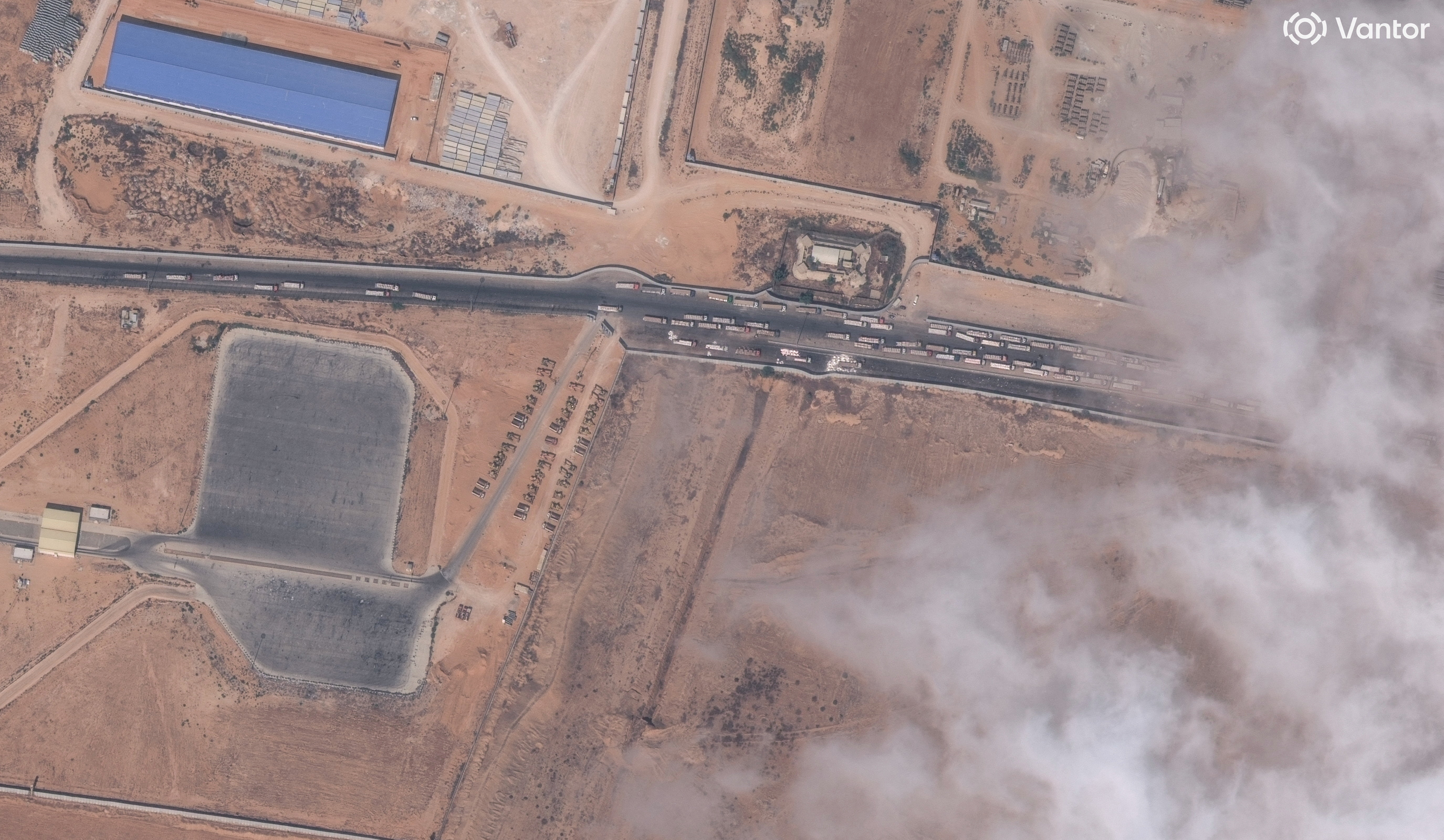 A satellite image shows trucks with aid waiting by the Egypt-Gaza border