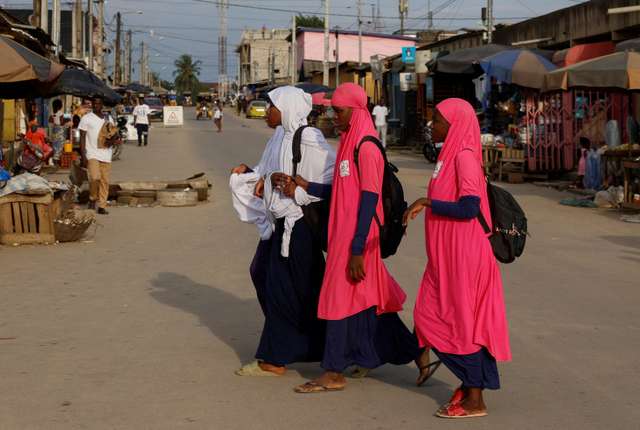 Muslim students walk on a street in Colombie, a slum of Abidjan, Ivory Coast October 8, 2024. REUTERS/ Luc Gnago