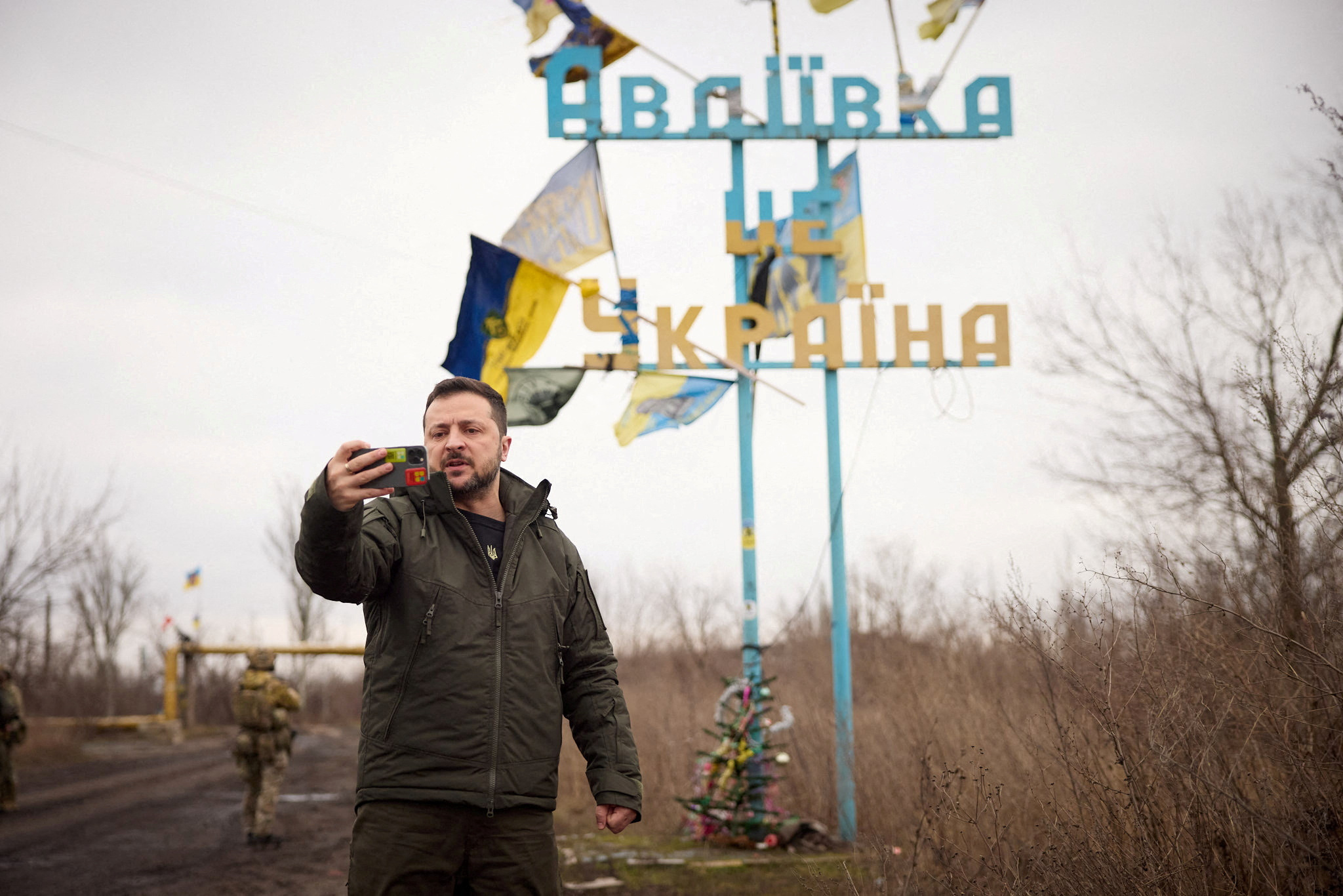 FILE PHOTO: Ukraine's President Zelenskiy takes a video, as he visits in the frontline town of Avdiivka