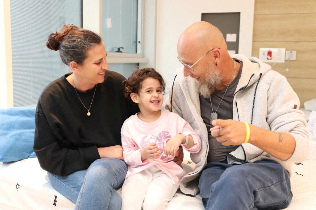 FILE PHOTO: Abigail Edan, who was released after being taken hostage during the October 7 attack by Palestinian militant group Hamas talks with her aunt Liron and uncle Zuli in Petah Tikva