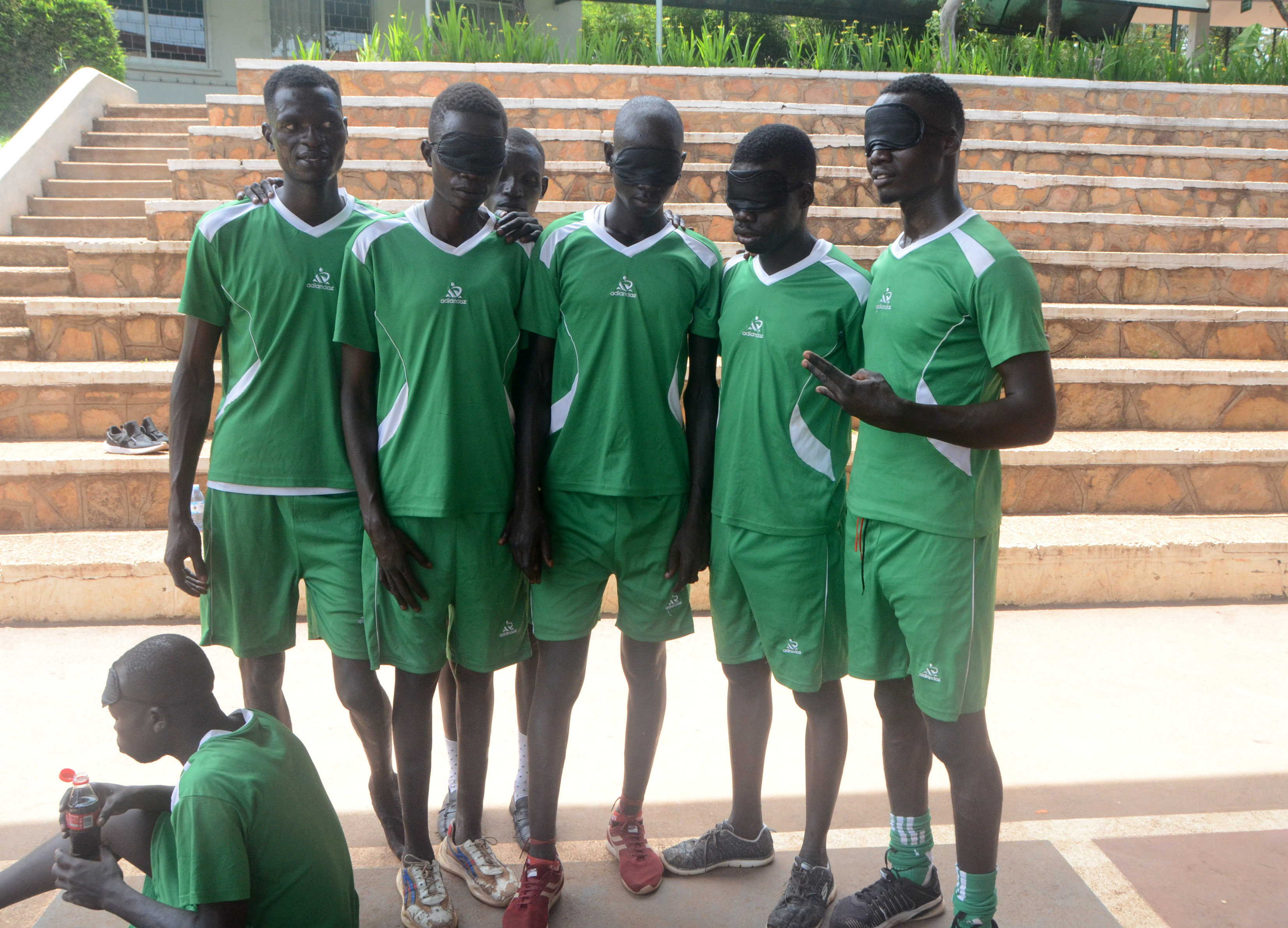 blind football players pose for group photo during the competition