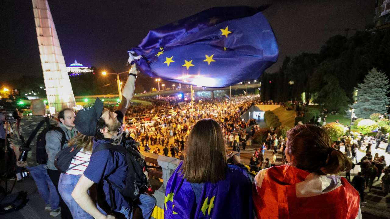 FILE PHOTO: Demonstrators hold a rally to protest against a bill on "foreign agents", in Tbilisi