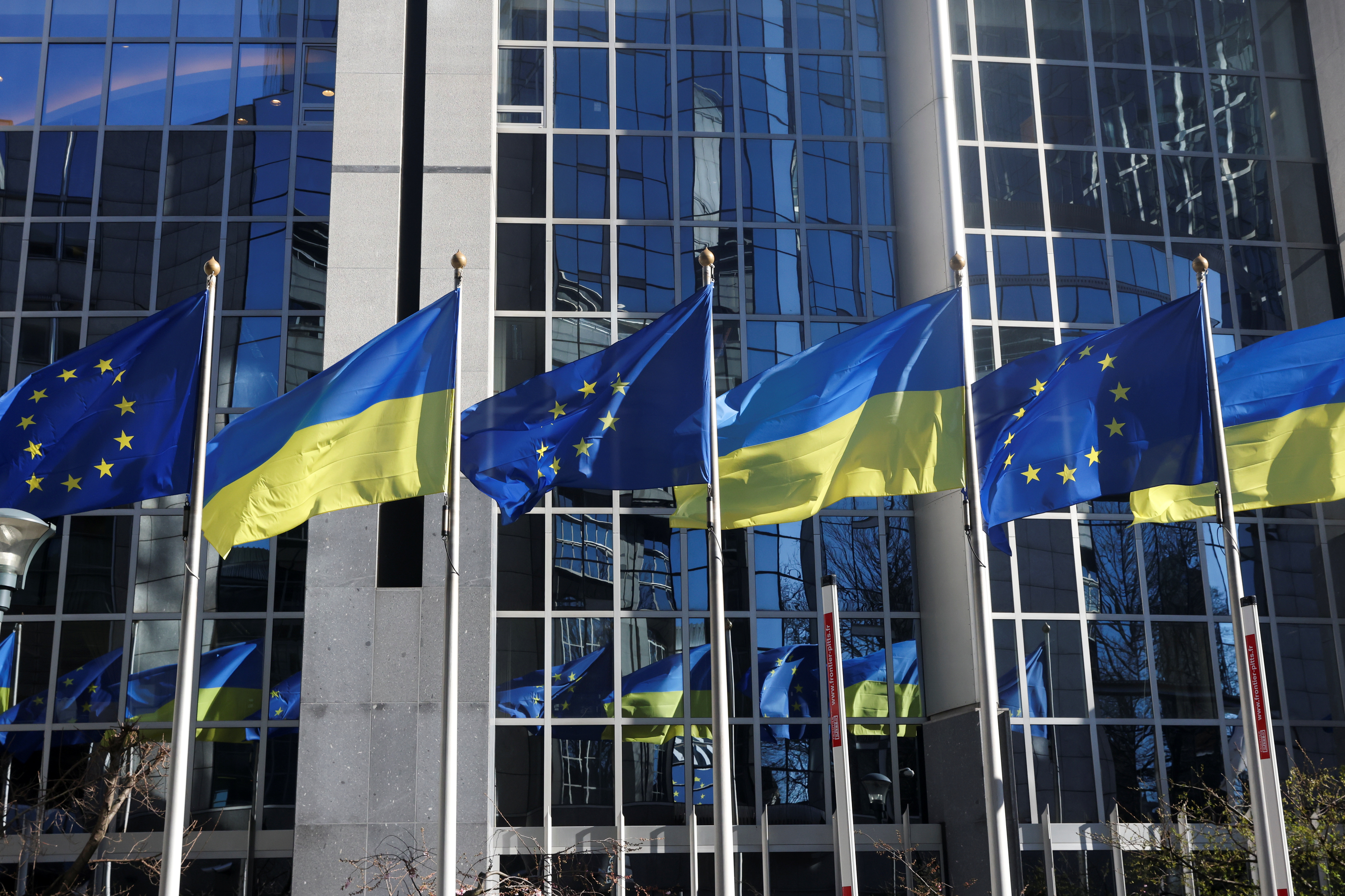 Flags of European Union and Ukraine flutter outside EU Parliament building, in Brussels