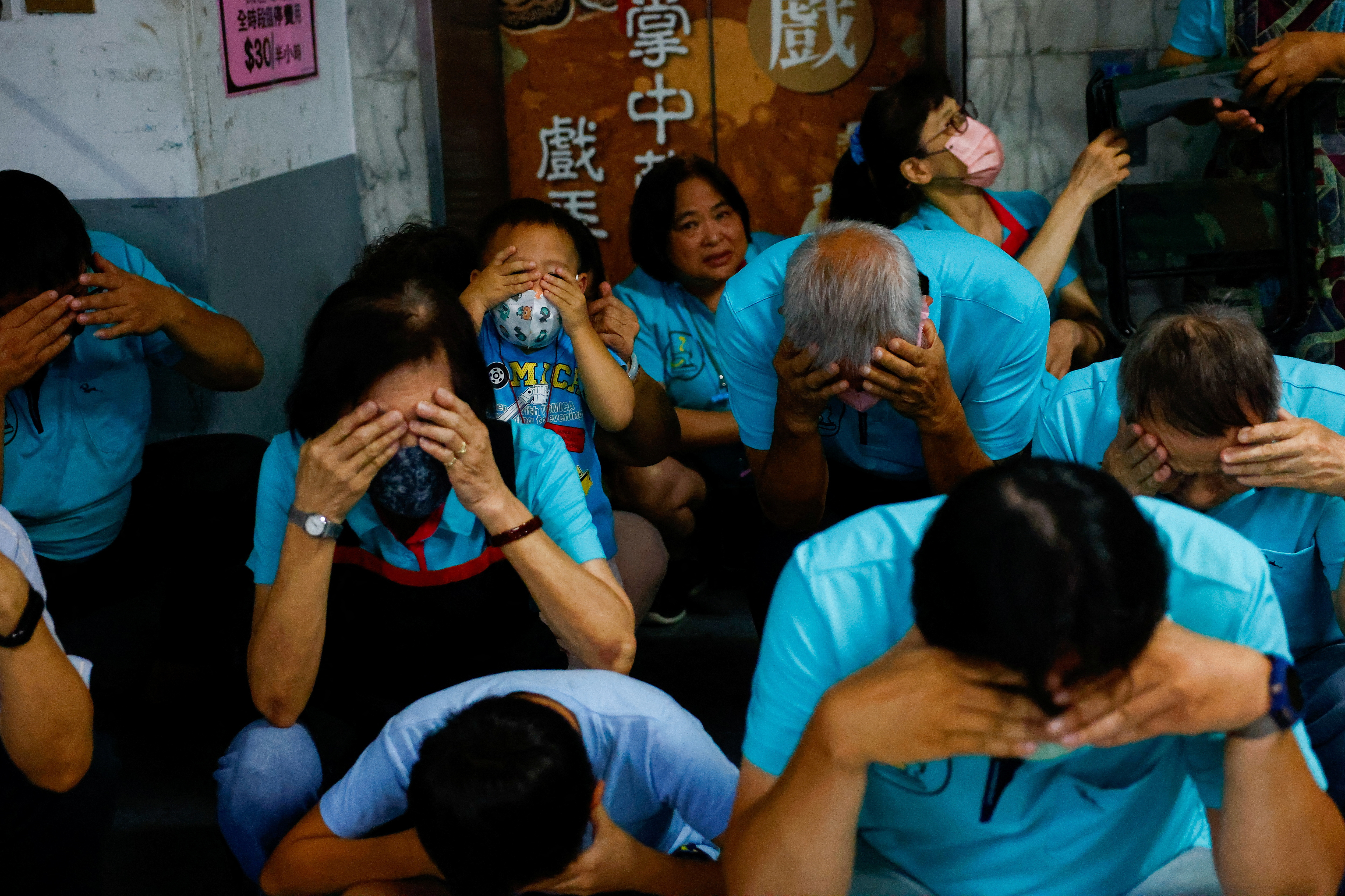 People participate in the annual air-raid exercise in Taipei