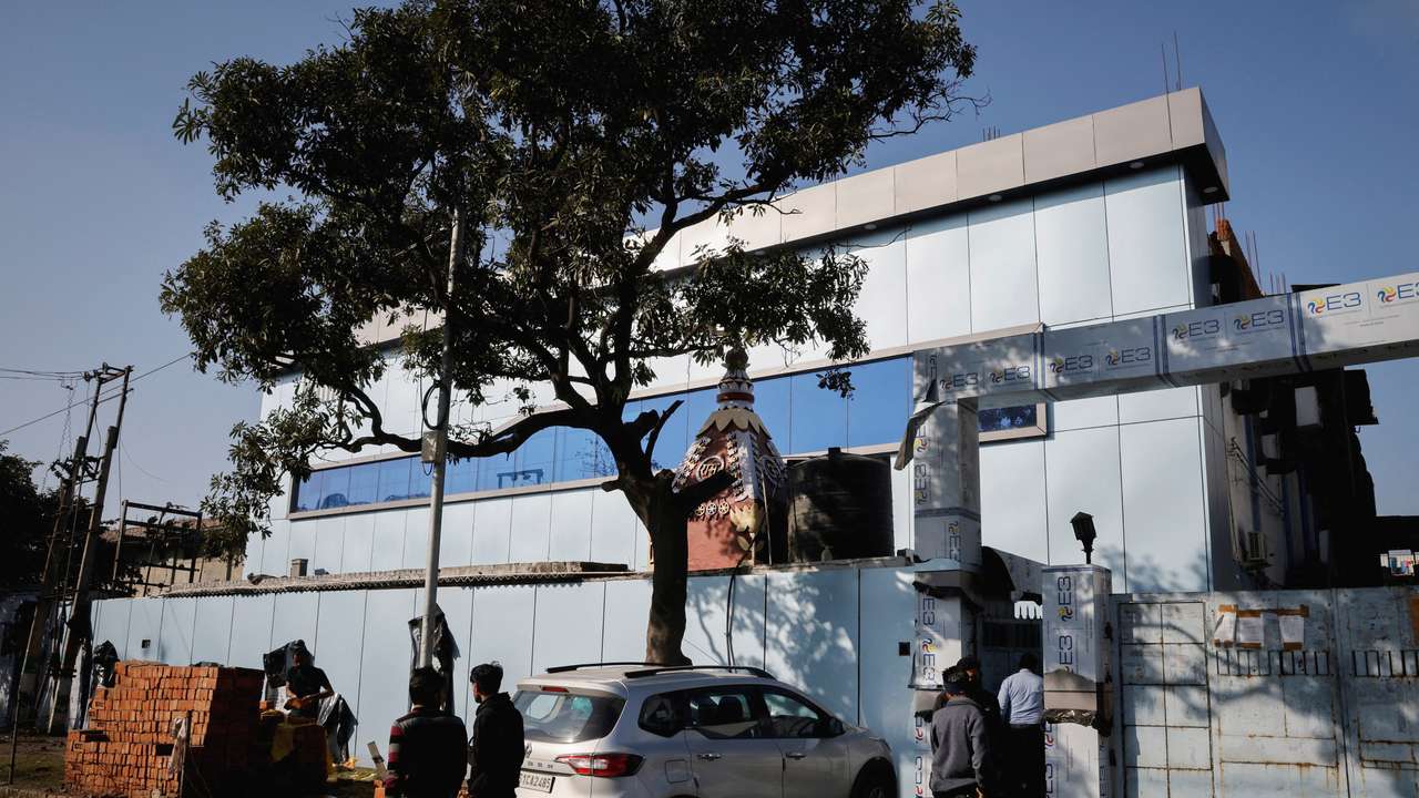 FILE PHOTO: People stand outside the Maiden Pharmaceuticals plant in Sonipat in the northern state of Haryana, India,