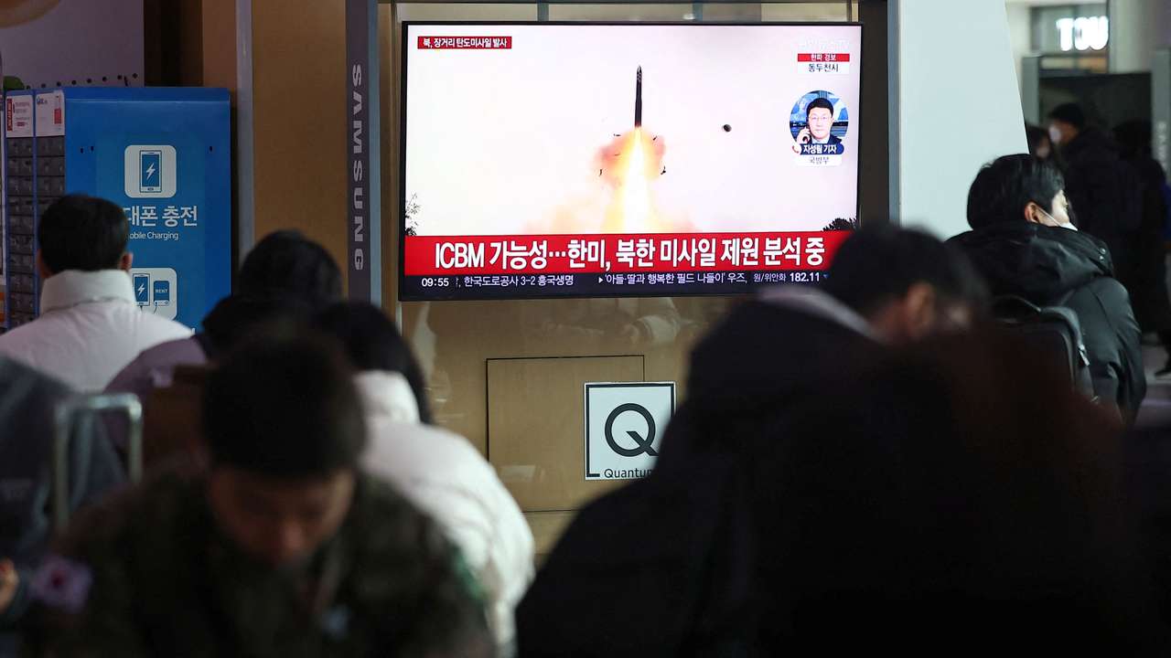 People watch a TV broadcasting a news report on North Korea firing what appeared to be a long-range ballistic missile, at a railway station in Seoul