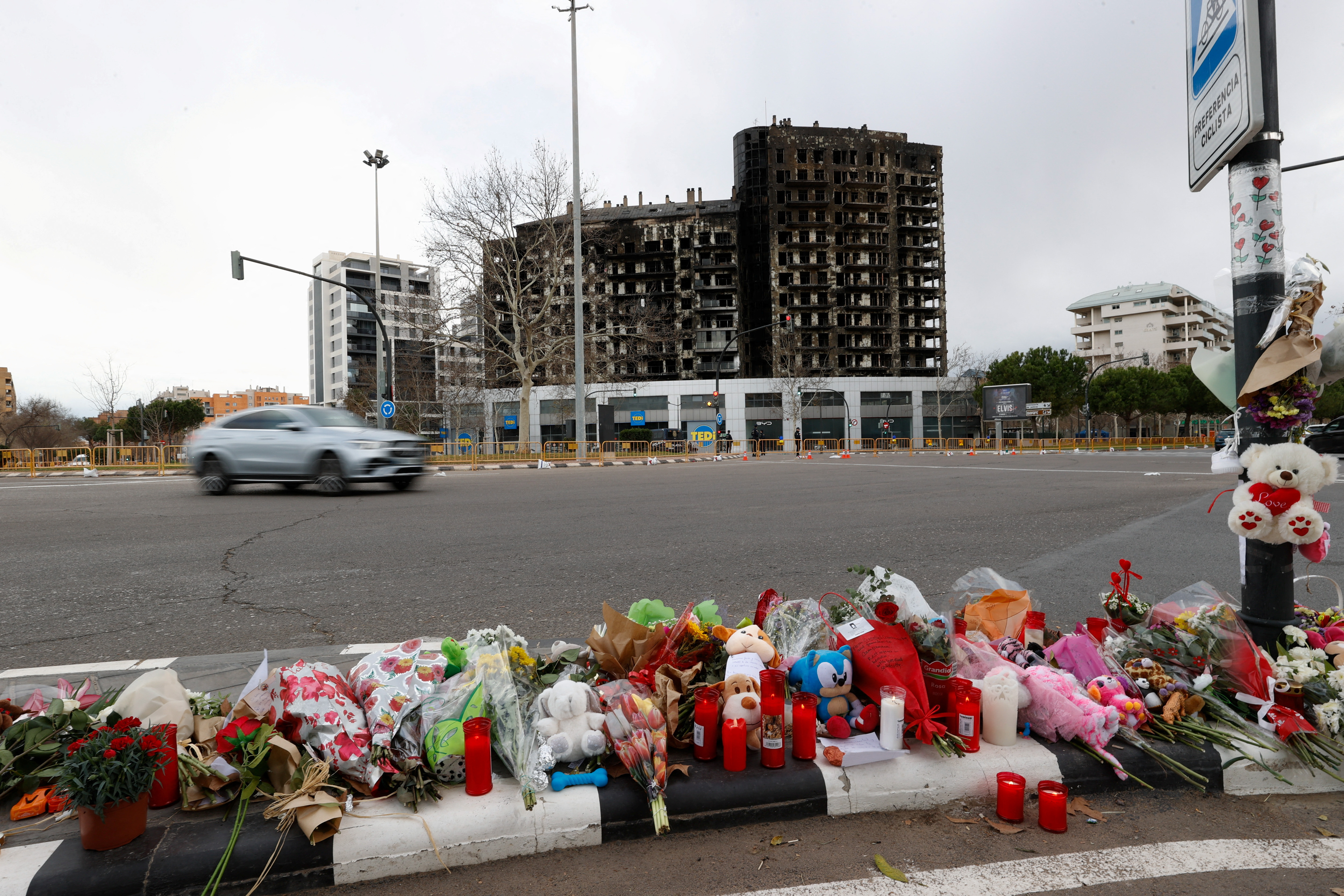 A makeshift memorial is pictured near the building that caught fire, in Valencia