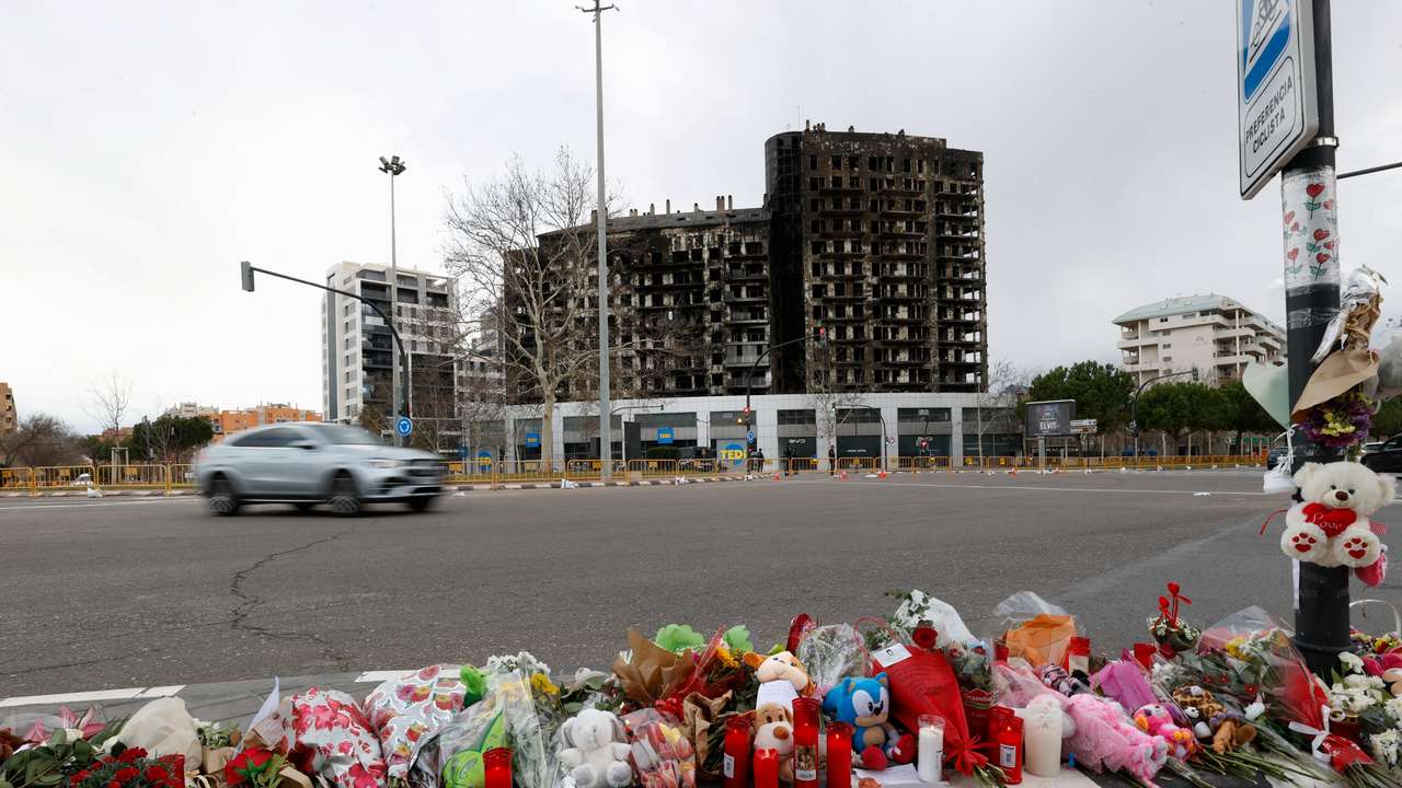 A makeshift memorial is pictured near the building that caught fire, in Valencia