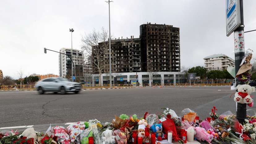 A makeshift memorial is pictured near the building that caught fire, in Valencia