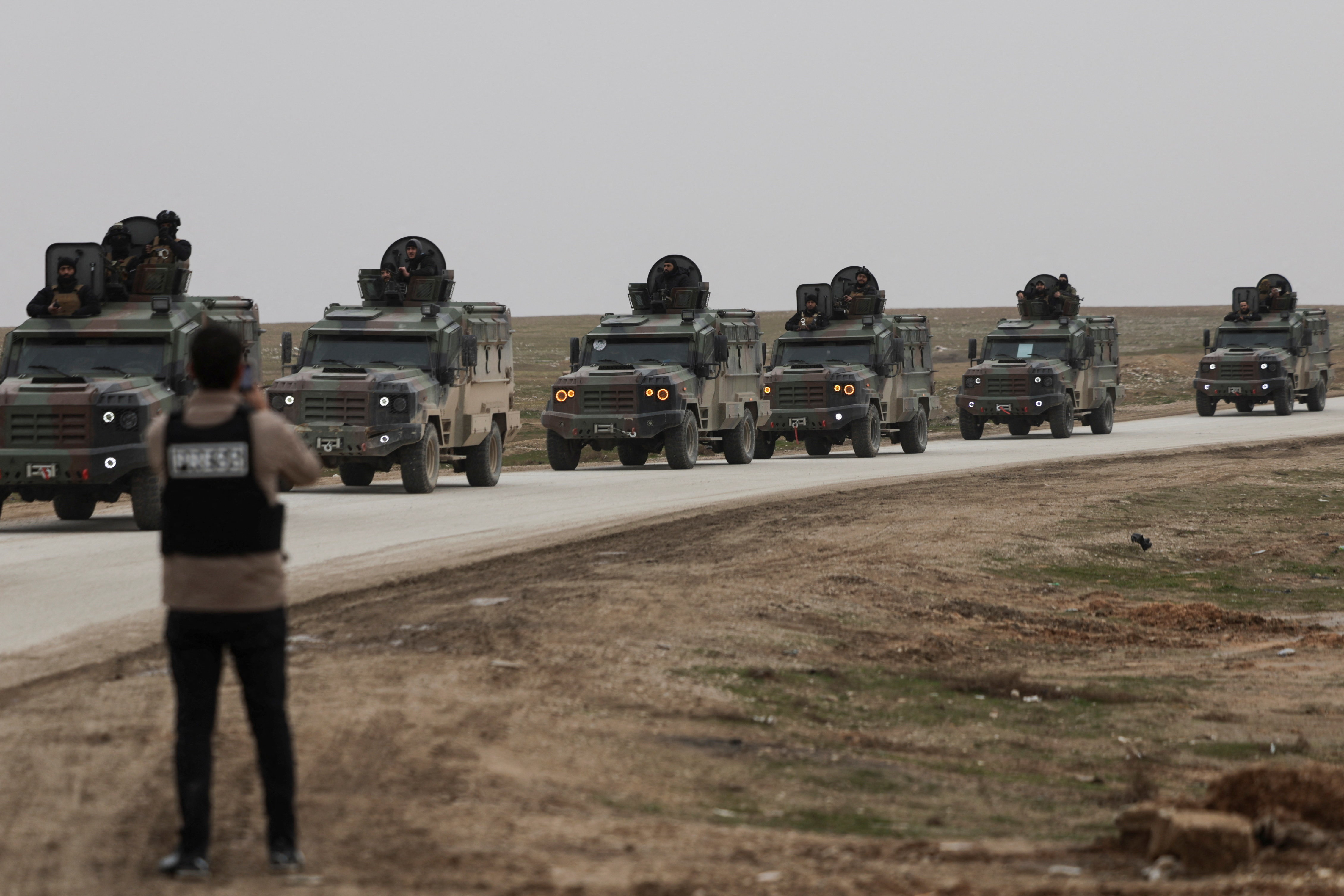 Syrian Interior Ministry security forces vehicles travel to enter the city of Hasakah