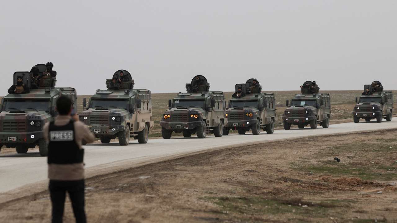 Syrian Interior Ministry security forces vehicles travel to enter the city of Hasakah