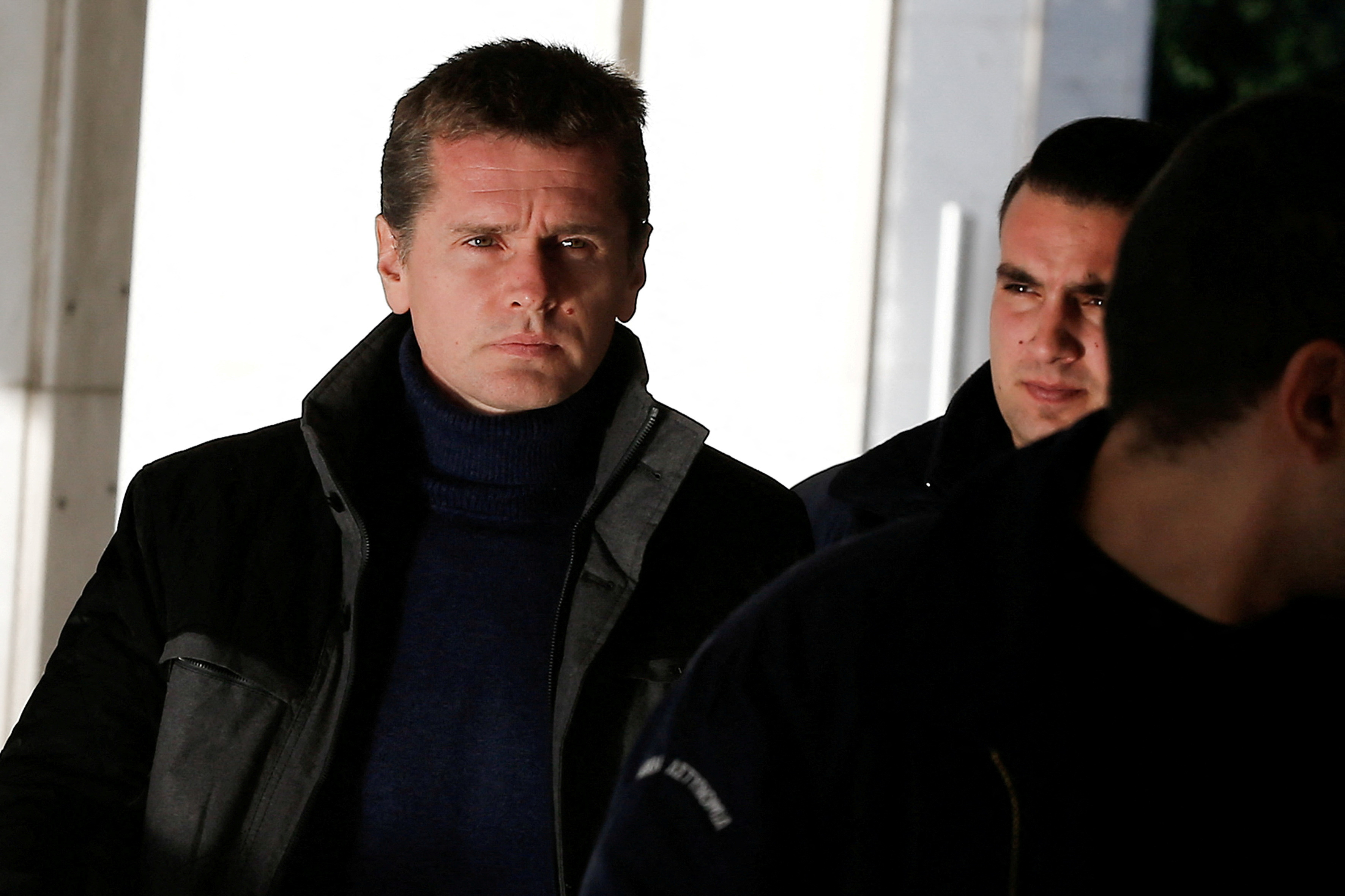 FILE PHOTO: Alexander Vinnik is escorted by police officers to a court in Athens