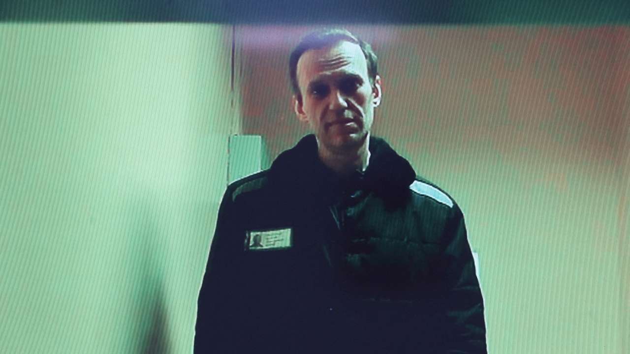 FILE PHOTO: Russian opposition leader Alexei Navalny is seen on a screen via video link during a court hearing in Moscow