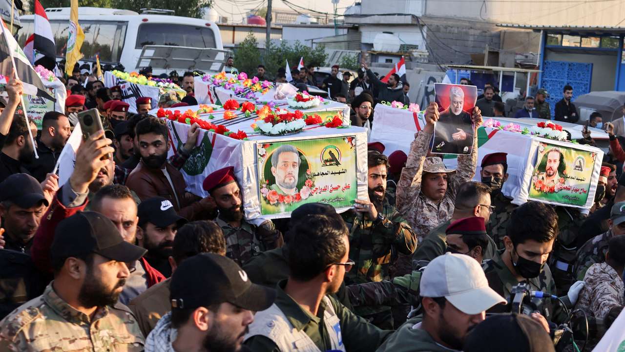 Mourners carry the coffins of Iraq's Kataib Hezbollah fighters who were killed by US airstrike in Jurf al-Sakhar, south of Baghdad