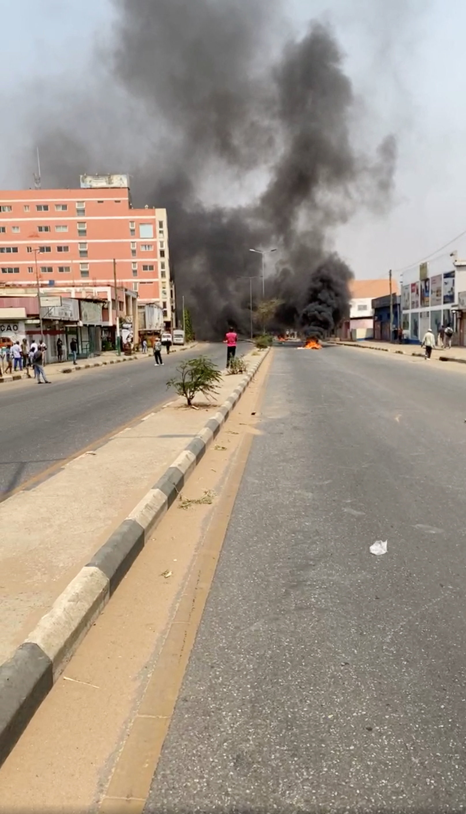 Smoke rises from a makeshit barricade blocking a road as people protest over a hike in the price of diesel, in Luanda