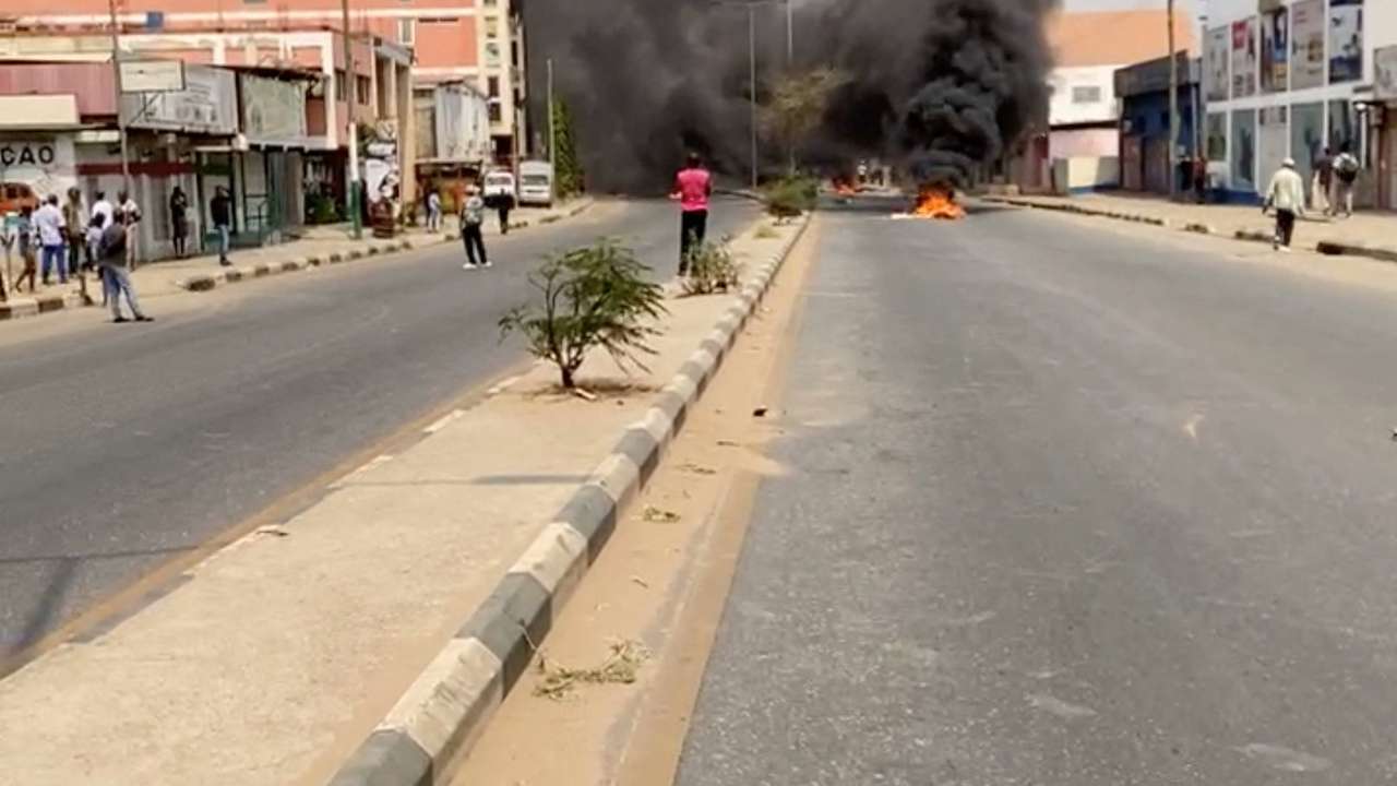 Smoke rises from a makeshit barricade blocking a road as people protest over a hike in the price of diesel, in Luanda