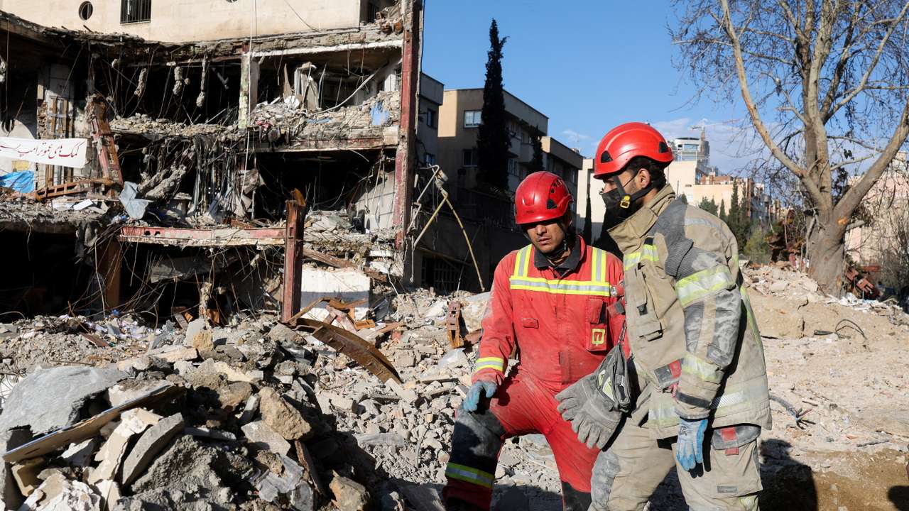 Members of a Red Crescent rescue team work at a building that was damaged by a strike, in Tehran