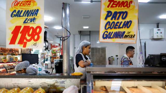 A chicken vendor works in a market in Sao Paulo
