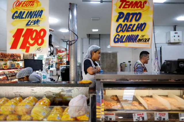 A chicken vendor works in a market in Sao Paulo