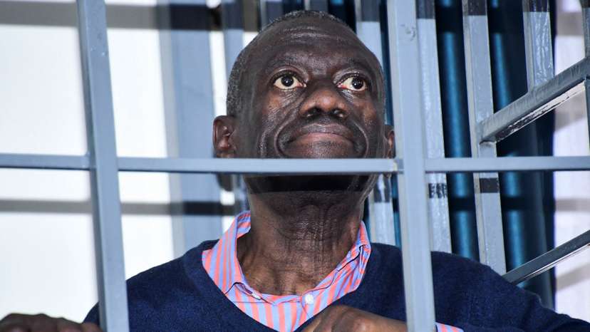 Opposition leader Kizza Besigye stands in a steel dock at the Uganda Military General Court Martial in Makindye, a suburb of Kampala