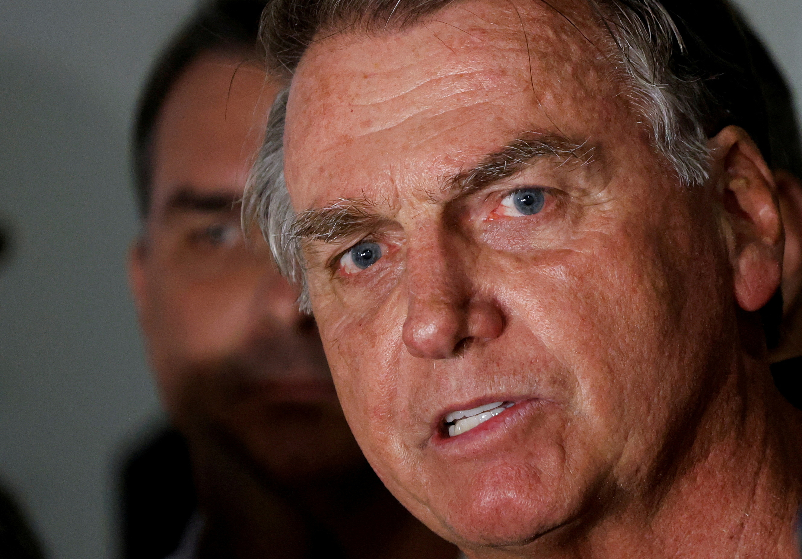 FILE PHOTO: Brazil's former President Jair Bolsonaro talks with media upon his arrival at Brasilia International Airport