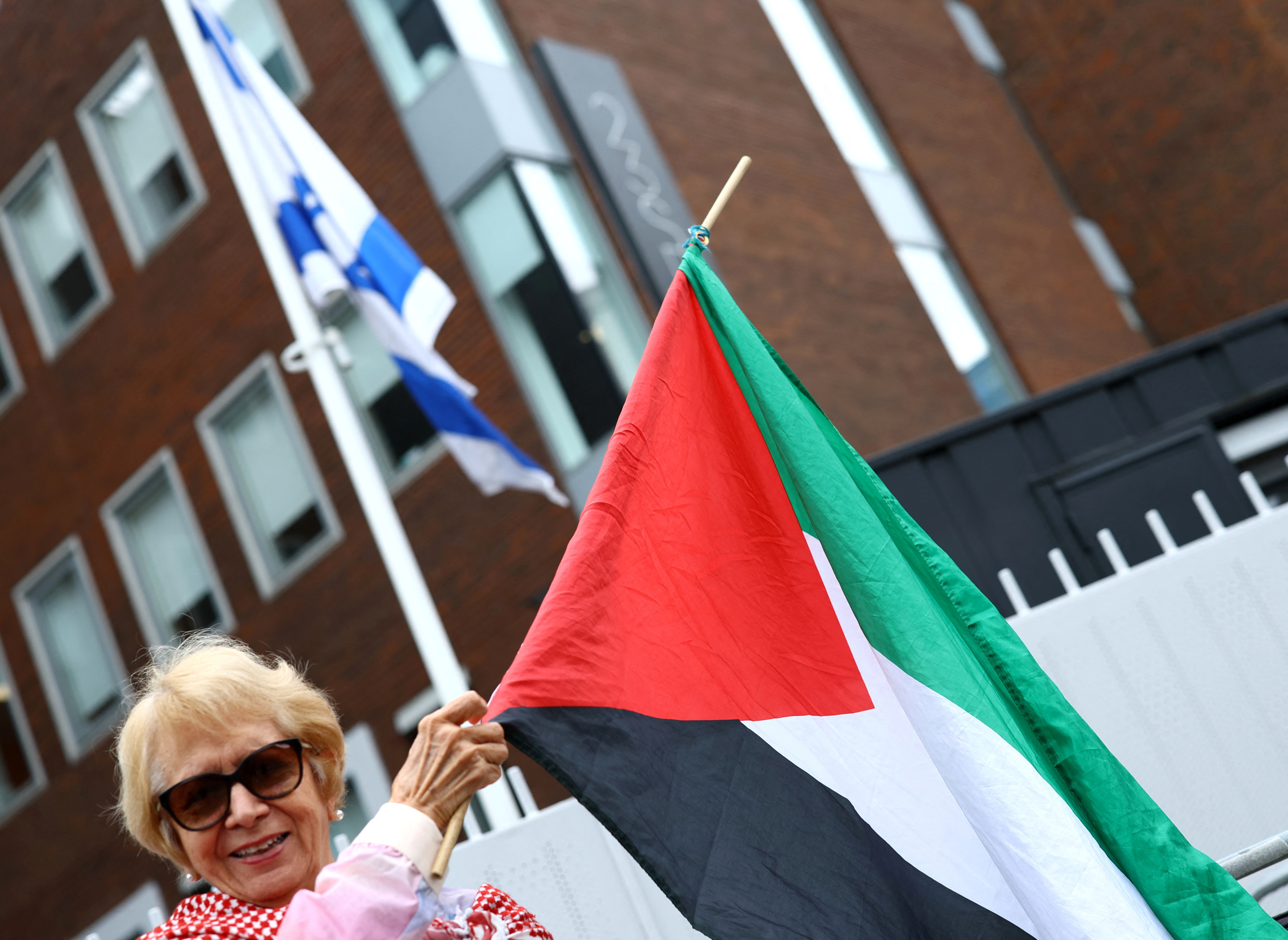 Demonstrators in support of Palestinians stand outside the Israeli embassy, in Dublin
