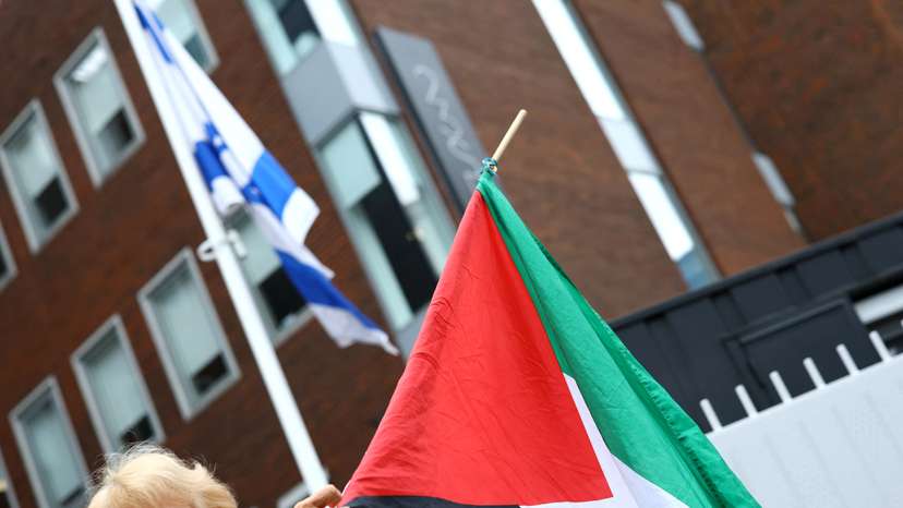 Demonstrators in support of Palestinians stand outside the Israeli embassy, in Dublin